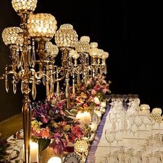 a long table is set with many glasses and candles for an elegant dinnereon party