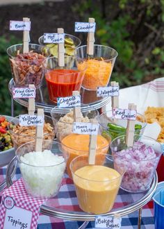 a table topped with bowls filled with different types of dips and condiments