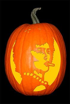 a carved pumpkin with the likeness of rock and roll singer elvis presley on it's face