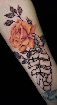 a rose on the arm with ribbon around it