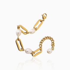 a gold chain bracelet with pearls on it