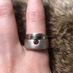 Vintage Flli Menegatti? sterling silver and 14k minimalist garnet ring. Chunky matte sterling ring with band of 14k gold and deep red faceted garnet. Stamped 925 585 (14k), signed VI, size 8, 8.71g. Modern Silver Ruby Ring With Polished Finish, Minimalist Silver Ruby Gemstone Ring, Modern Garnet Jewelry, Minimalist Silver Ruby Ring Gift, Modern Sterling Silver Birthstone Ring For Everyday, Modern Garnet Rings For Anniversary, Modern Garnet Jewelry For Gift, Modern Garnet Jewelry As A Gift, Sterling Silver Rings With Tension Setting For Everyday