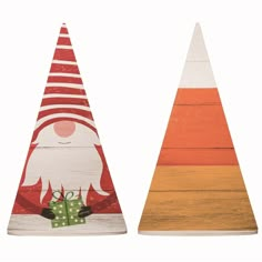 two wooden christmas trees with santa and presents on them