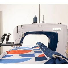 a sewing machine with blue and orange designs on it