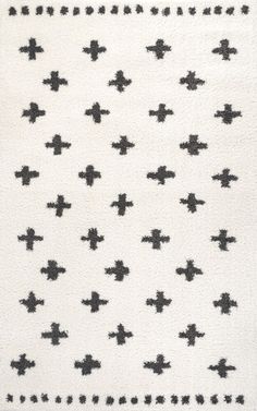 a white rug with black crosses on it