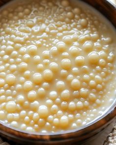 a bowl filled with white beads on top of a table