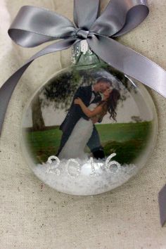 a glass ornament with an image of a bride and groom on the front