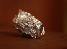 a piece of tin foil sitting on top of a wooden table