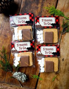 three bags of s'mores to go sitting on top of a wooden table