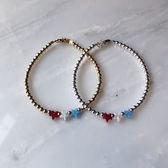 We're celebrating America in the way we do best - with jewelry handmade in the USA (Hoboken, NJ)! This listing is for one of our three red, white, and blue bracelet styles. Choose a triple mini heart bracelet, a triple mini star bracelet, or a swarovski bracelet. Also choose between gold-filled, rose gold-filled, and sterling silver finishes. One inch of extra chain lets you adjust the bracelet to your preference. All items are hand-made in the USA in a smoke-free studio, and most importantly, t Beaded Bracelets With Star Charm For Gifts, Silver Beaded Bracelet With Star Charm For Gift, Silver Beaded Bracelets With Star Charm As Gift, Silver Beaded Bracelet With Star Charm As Gift, Star-shaped Beaded Friendship Jewelry, Star-shaped Spacer Beads Jewelry For Gift, Handmade Star-shaped Spacer Beads Jewelry Gift, White And Blue Bracelet, Bracelet Styles