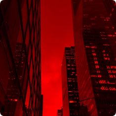 the red sky is reflected in tall buildings