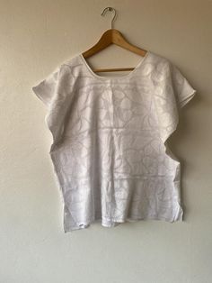 This amazing Mexican huipil or blouse is made of white fabric with white embroidery.  This type of embroidery is typical from the Mazatec ethnic group from Jalapa de Díaz, in Oaxaca state, southern Mexico.  Animals and floral motives are embroidered onto de fabric to make these master pieces. We have many other boluses, please take a look at my shop if you want another color or send me a convo. :)MEASUREMENTS: It is a square pieceWidth, Arm pit to arm pit: 22 inches/ 58 cm Length: 26 inches / 64 Traditional Linen Tops With Chikankari Embroidery, Summer White Blouse With Tonal Embroidery, Traditional White Chikankari Embroidered Top, White Cotton Tops With Tonal Embroidery, White Folk Tops With Geometric Embroidery, White Cotton Blouse With Tonal Embroidery, White Bohemian Blouse With Chikankari Embroidery, Traditional White Tops With Chikankari Embroidery, White Short Sleeve Tops With Tonal Embroidery