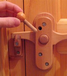 a person is opening a wooden door handle