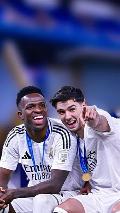 two soccer players are posing for the camera