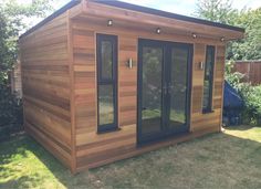 a small wooden building sitting in the grass