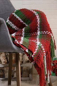 a red and green blanket sitting on top of a chair