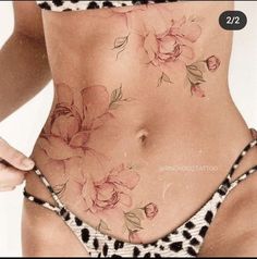 a woman's stomach with flowers on it and the bottom part of her body