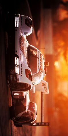 a close up of a toy race car on a stand with the sun in the background