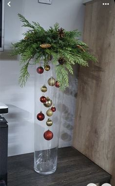 a vase filled with ornaments on top of a wooden table