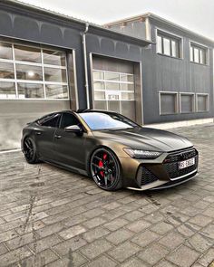 a grey car parked in front of a building