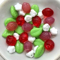 a bowl filled with gummy bears sitting on top of a table