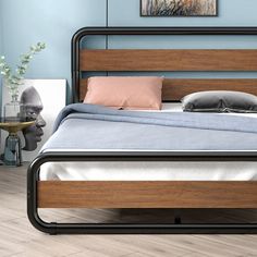 a bed with wooden headboard and metal frame