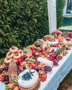 a table covered with lots of different types of fruits and pastries on top of it