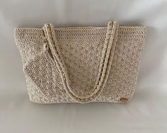 Discover our 2 in 1 patterned crochet bag in beige, a perfect choice for handmade crochet bag enthusiasts!  👜 Designed to complement any style, this bag features an elegant pattern and comfortable shoulder strap for easy daily use. It was made using slim supra thread that will give you a stunning look in the summer nights. 📏Measuring 8.27 inches height, 11.42 inches width, and with a lined interior, it's the perfect size for carrying your essentials. The 7.87 inches handle drop allows for comfortable wear over the shoulder. It is made by weaving onto a gold-colored chain.  👛The purse-shaped accessory on the handle of the bag adds a stylish look.     *This is not a purse.* 🎁💝 It also makes a great gift option for women who appreciate unique and stylish accessories. Our bag is carefully Luxury Natural Colored Bag As A Gift, Luxury Natural-colored Bag As A Gift, Luxury Natural Color Bag As Gift, Luxury Natural Color Bag For Gift, Luxury Natural Color Bags For Gifts, Elegant Shoulder Bag With Detachable Handle In Natural Color, Elegant Natural Shoulder Bag With Detachable Handle, Luxury Crochet Pouch Bag For Daily Use, Elegant Natural Color Shoulder Bag