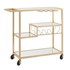 a gold metal and glass serving cart with two shelves on wheels, one holding wine glasses