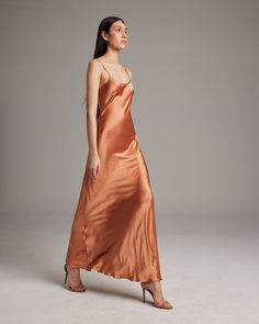 Named by Vogue as a must-have, this easy to wear luxury charmeuse slip dress is the perfect day to night staple. Featuring a bias cut and the finest silk quality, it shapes flatteringly to every type of body. Bias cut silk charmeuse slip elegantly drapes on the body. 100% Silk Charmeuse Made in New York City Model is wearing a size S and is 5'10" Product Care: Dry Clean Only City Model, Silk Dress Long, The Perfect Day, Silk Slip Dress, Boatneck Sweater, Silk Tank, Silk Slip, Silk Charmeuse, Perfect Day