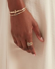 The Triple Band Ring is made up of three intertwined bands, each featuring petroglyph motifs and faceted Hampton blue topaz stones. This design is perfect for solo wear or stacked. Inspired by the three US Virgin Islands - St. John, St. Thomas, and St. Croix, the three stones symbolize their unique beauty. Metal: 14K solid gold Stone: Hampton blue topaz Band Width: 6mm Stone Size: 5mm x 3.5mm Style #: GR139Hb Fine Jewelry Double Band For Promise, Double Band Yellow Gold Promise Jewelry, Yellow Gold Double Band Promise Jewelry, Yellow Gold Double Band Jewelry For Promise, Stackable Double Band Promise Jewelry, Modern Twist Stackable Promise Jewelry, Triple Band Ring, Us Virgin Islands, St Croix