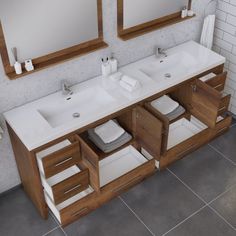 a bathroom with two sinks and mirrors on the wall