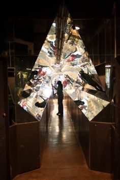 a person standing in front of a large piece of art that looks like a star