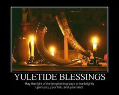 candles are lit in front of a poster with the words yuletide blessings