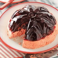 a chocolate covered dessert sitting on top of a white plate