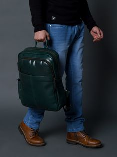 Make a bold statement with this head-turning Italian green leather backpack that radiates confidence and style. The glossy finish enhances its vibrant sea green color, creating a mesmerizing and eye-catching accessory. The sleek design and luxurious feel of the leather makes it a standout piece in any fashion ensemble, promising to elevate your look with a touch of glamour. Whether navigating city streets or making a grand entrance at an event, this bold and eye-catching green leather backpack i Modern Green Travel Backpack, Rectangular Green Leather Backpack, Modern Green Backpack With Zipper Closure, Modern Green Backpack, Green Modern Business Bag, Modern Green Business Bags, Modern Green Leather Backpack For Travel, Modern Green Leather Backpack, Modern Green Rectangular Backpack