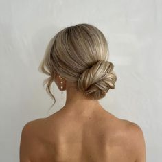 a woman with blonde hair in a low bun