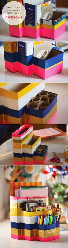 three stacks of different colored boxes stacked on top of each other with pens and pencils in them