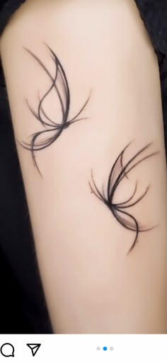 a woman's arm with two black feathers on the left side of her body