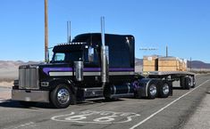 a large semi truck driving down the road