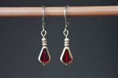 Small Red Earrings, Czech Glass Earrings, Red Dangle Earrings, Drop Earrings, Teardrop Earrings, Gift For Women, Gift for Her Lovely, tiny dangle earrings made with red teardrop czech glass beads and gold tone plated spacer beads. They hang from antique brass lever backs ( lead and nickel free). Color : Red teardrop and gold Czech glass beads. Finish : Antique gold plated spacer beads, antique brass findings Length : 1 1/8 inches including the antique brass lever back Ear wires : Antique brass l Red Nickel-free Teardrop Dangle Earrings, Nickel Free Red Teardrop Earrings, Nickel Free Red Drop Earrings, Nickel-free Red Teardrop Earrings, Red Nickel-free Teardrop Earrings, Red Earrings Dangle, Earrings Teardrop, Earrings Red, Red Earrings