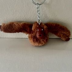 a brown stuffed animal hanging from a key chain