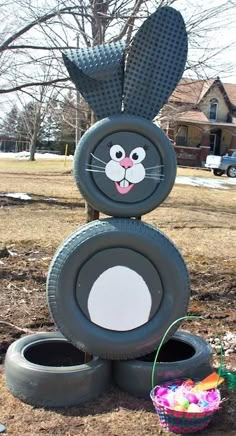 an easter decoration made out of tire tires with a bunny face on it's head