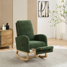 a green rocking chair sitting on top of a white rug