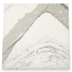 a white and gray marble tile with some black dots on the top, in front of a white background