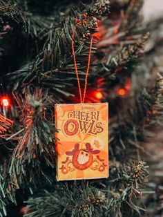 an ornament hanging from the christmas tree that says cheer ows on it