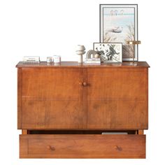 a wooden dresser with drawers and pictures on top