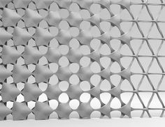 a black and white photo of a wall made out of circles with holes in the middle