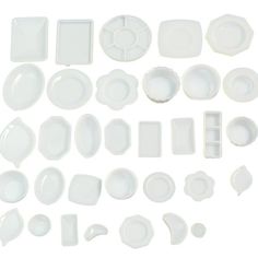 white dishes and plates are arranged on a white background