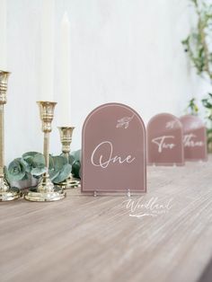 the table is set up with candles and place cards